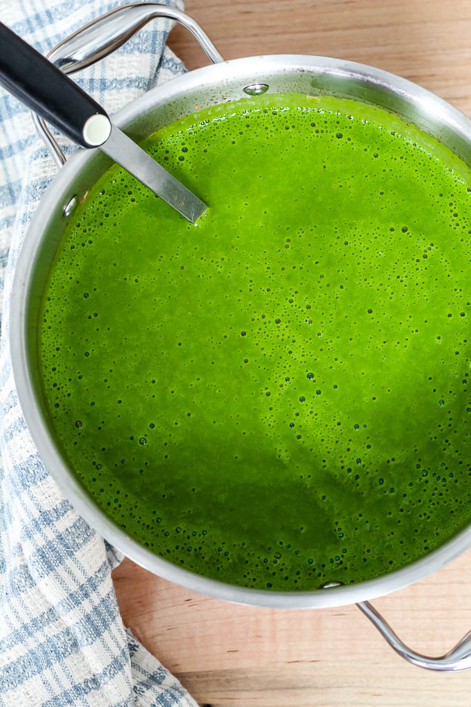 an overhead shot of a full soup pot of vegan spinach potato soup 