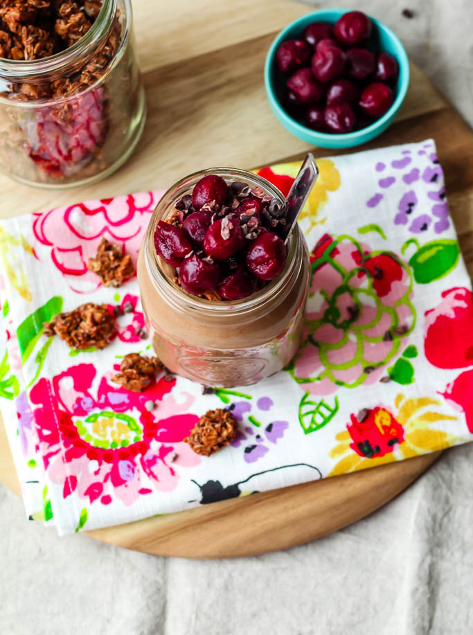 overhead shot of the smoothie topped with frozen cherries and granola 