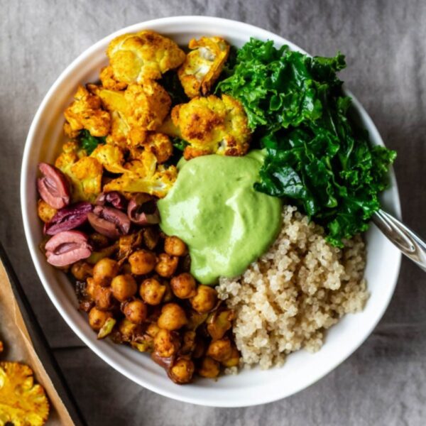 close up overhead view of the bowl of Moroccan-spiced chickpeas, quinoa, veggies, and sauce