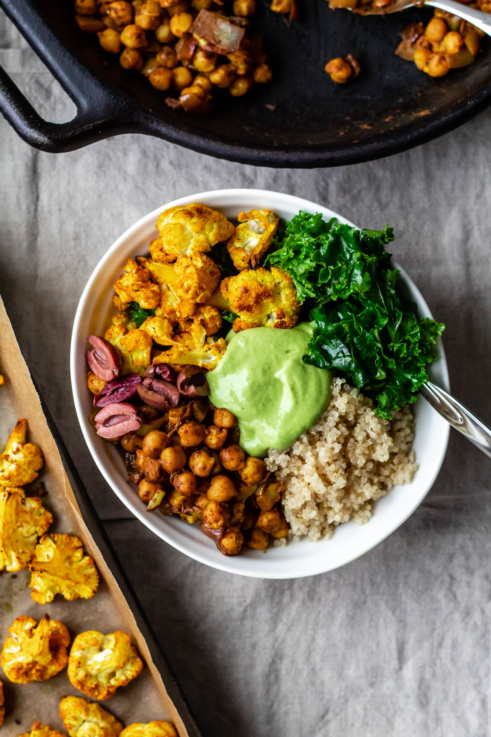 overhead shot of a moroccan chickpea bowl against a grey background