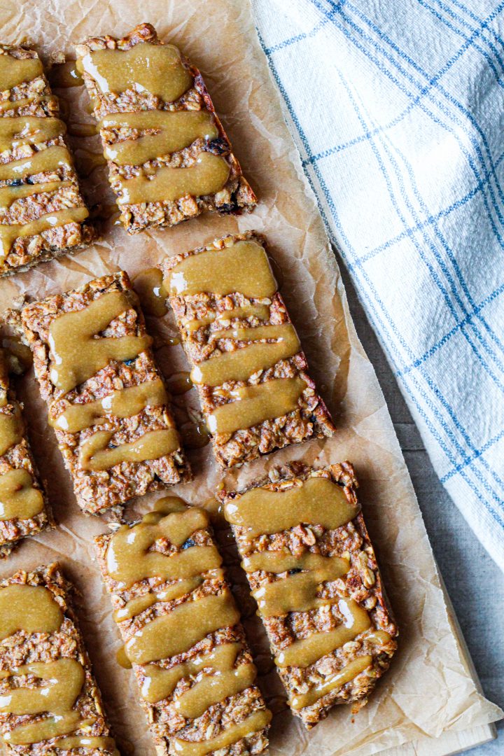 overhead shot of the energy bars on a wooden board with tahini maple drizzle on top