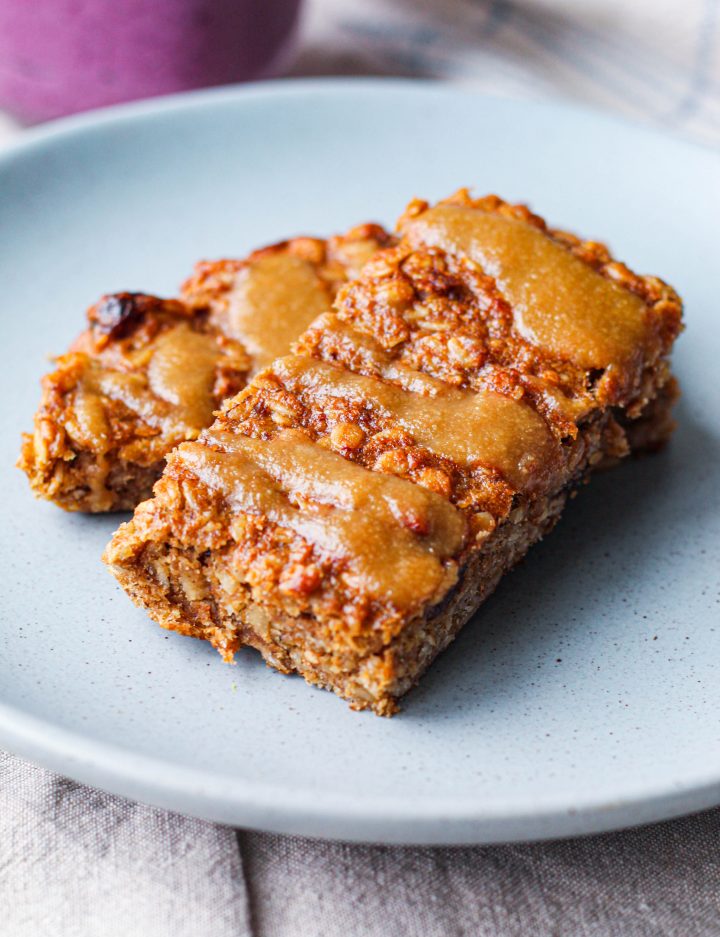 straight on shot of 2 banana oatmeal bars on a blue plate 