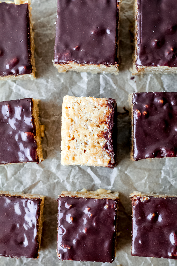 overhead shot of the full batch of peanut butter and honey rice crispy squares against parchment paper