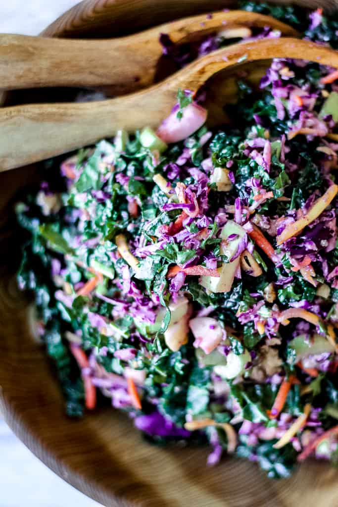 overhead close up shot of the slaw in a wooden salad bowl