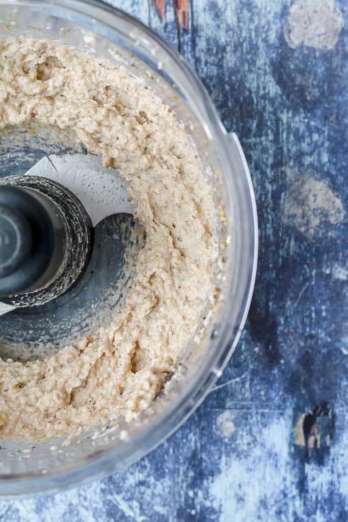 overhead shot of the buckwheat pizza crust mixture in a food processor 