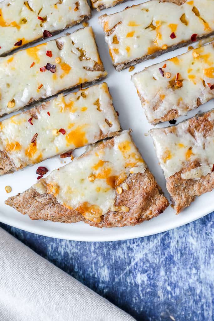 an overhead close up shot of a slice of buckwheat crust pizza topped with cheese 