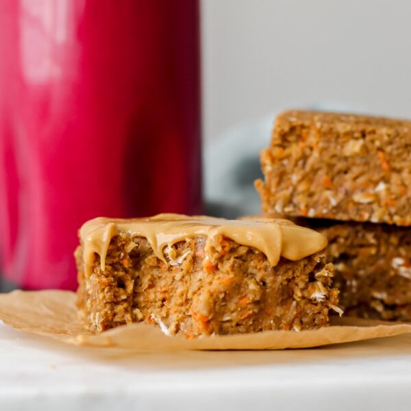close up of a carrot cake oatmeal bar with a bite taken out of it