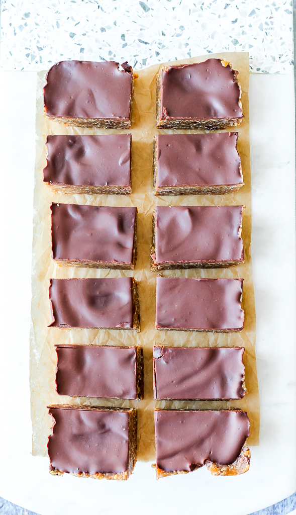 an overhead shot of the twelve cookie dough bars on a white marble board 