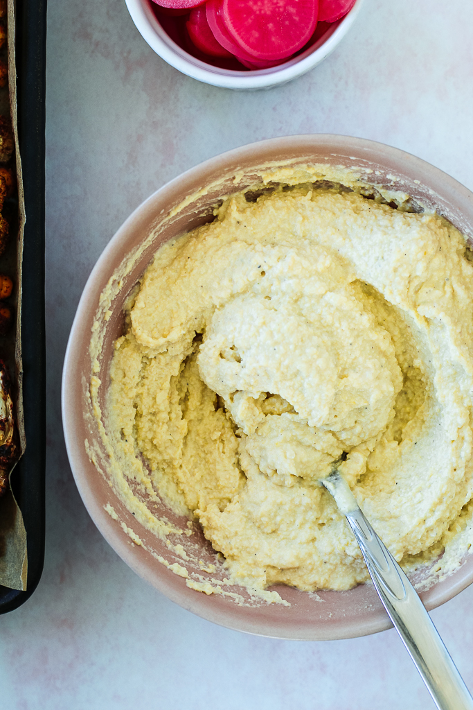 an overhead photo of the hummus in a pink bowl