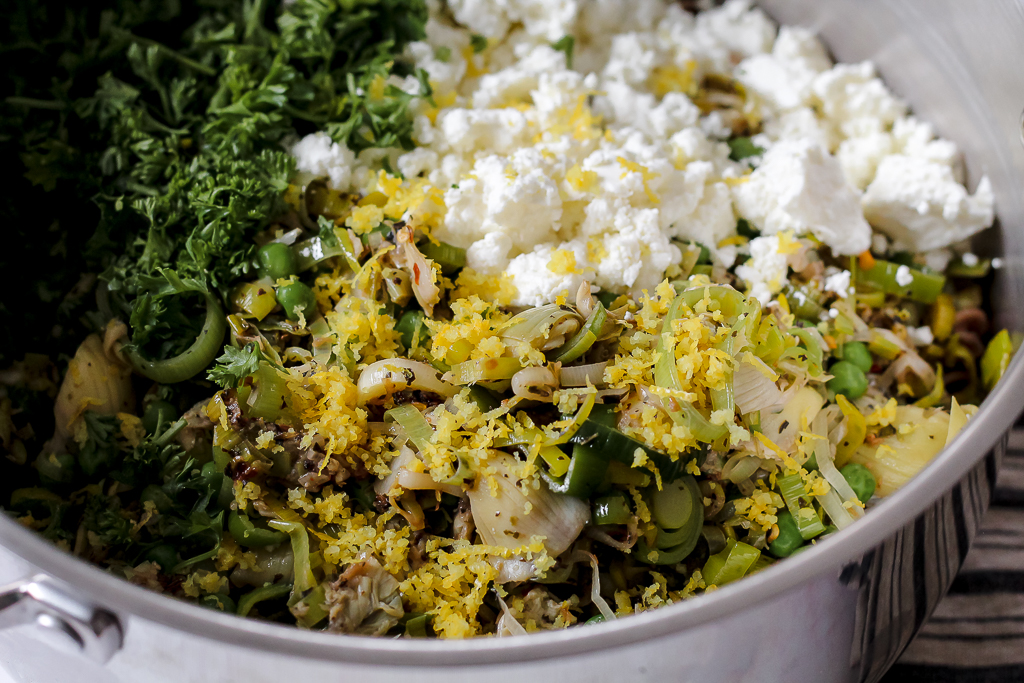 straight on shot of a pot full of the creamy goat cheese pasta ingredients in a big pot before being tossed all together 