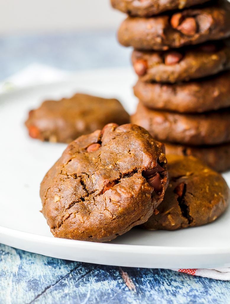 close up straight on shot of two vegan double chocolate cookies on a white plate 