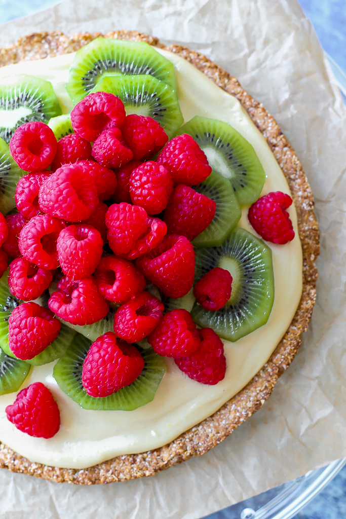 an overhead shot, close up, of the vegan fruit pizza on a cake plate