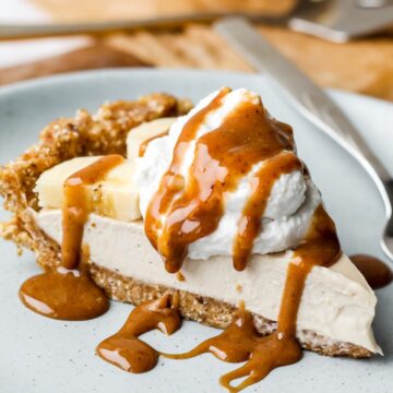 close up straight on photo of a slice of banana cream pie on a blue plate