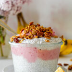 straight on shot of a bowl of chia pudding and cherry banana soft serve parfait on a white table