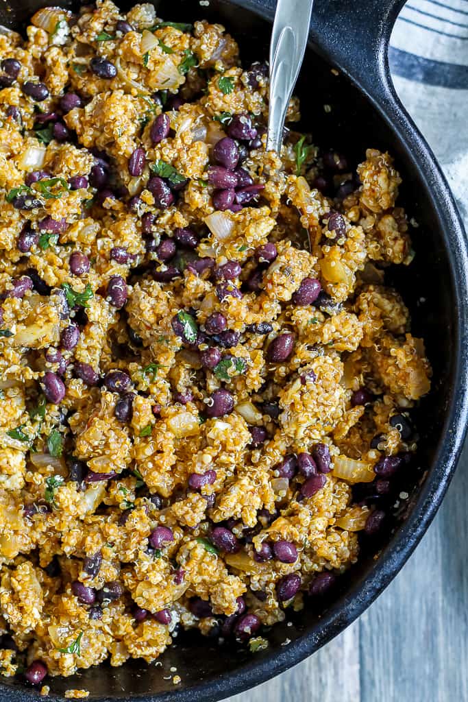 overhead shot of the quinoa, beans, and chicken in a skillet