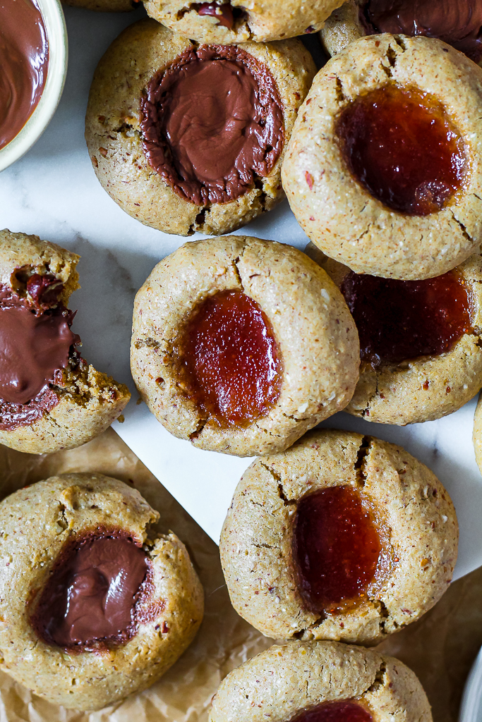 overhead photo of the two types of thumbprint cookies on a white board 