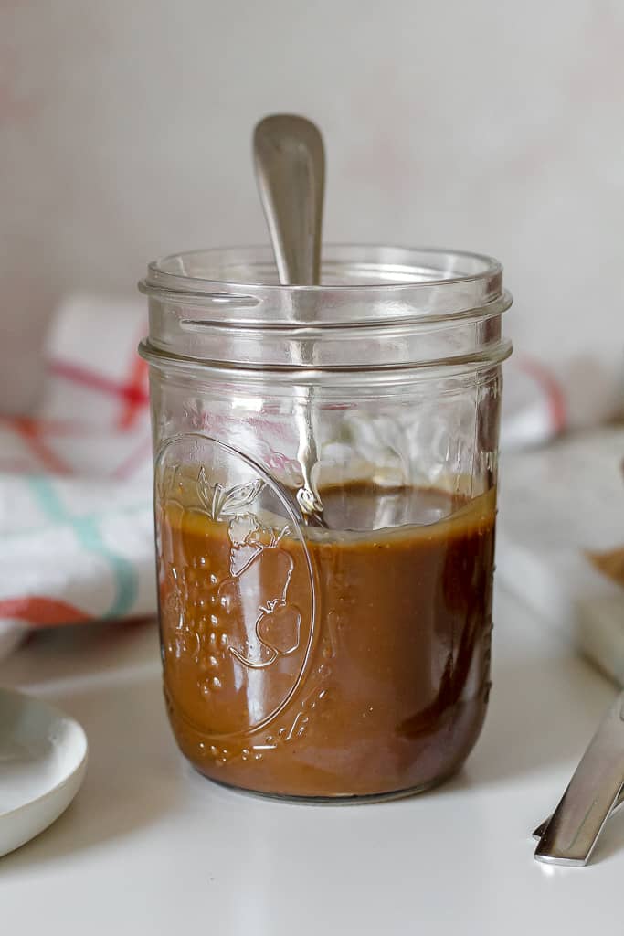 straight on shot of a jar of coconut caramel sauce 