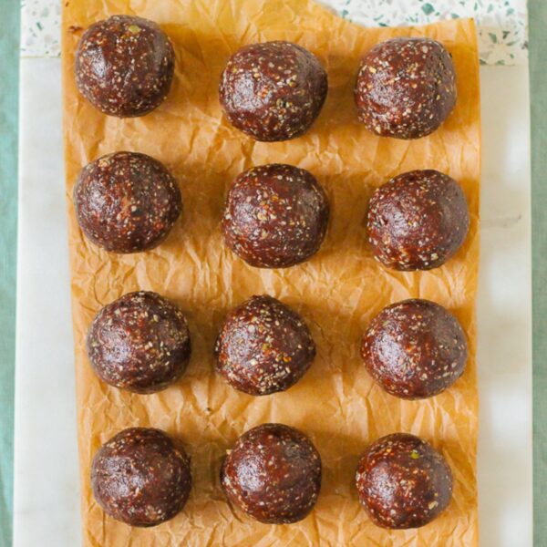 overhead photo of chocolate energy balls on a sheet of parchment paper