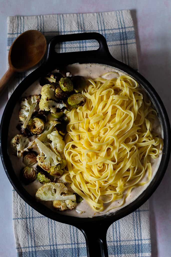 the cooked pasta and roasted vegetables added to the white bean sauce