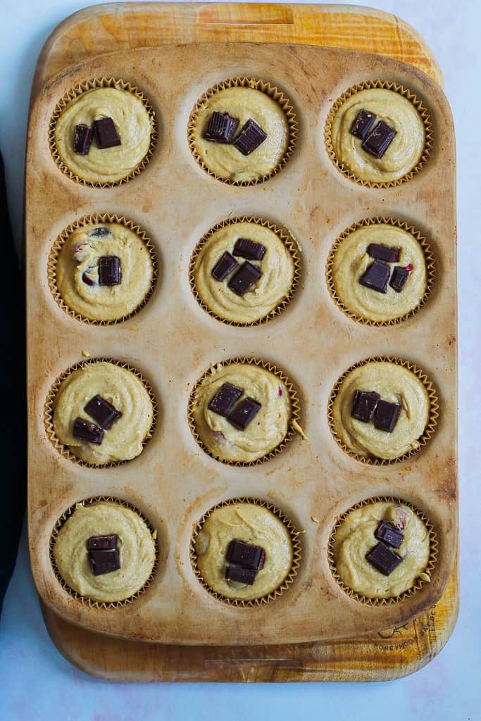 a process shot showing the muffin batter in the muffin pan before being baked