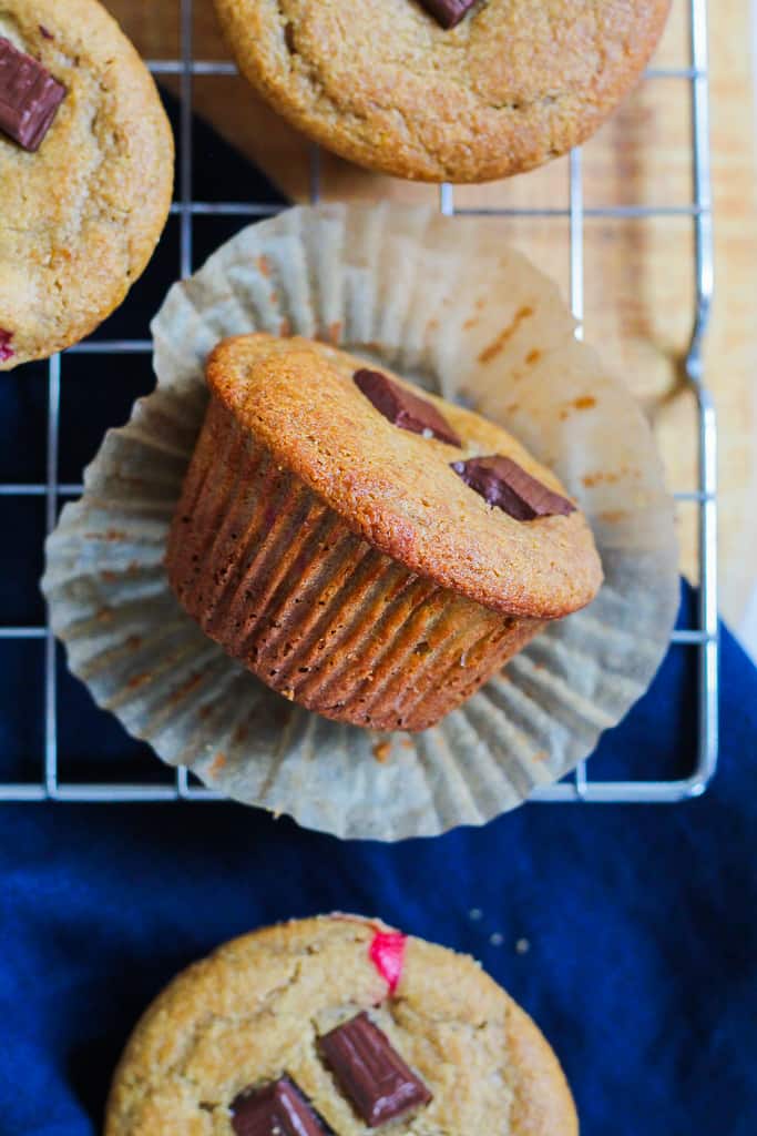 an overhead shot of a muffin flipped on its side with the paper liner peeled off to show what it looks like on the outside