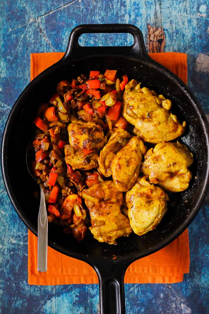 an overhead shot of the chicken and veggies in the skillet