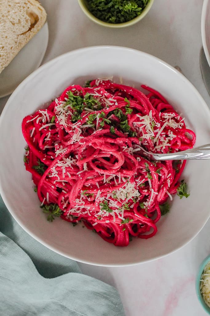 overhead close up of a bowl of the pasta on a light pink background