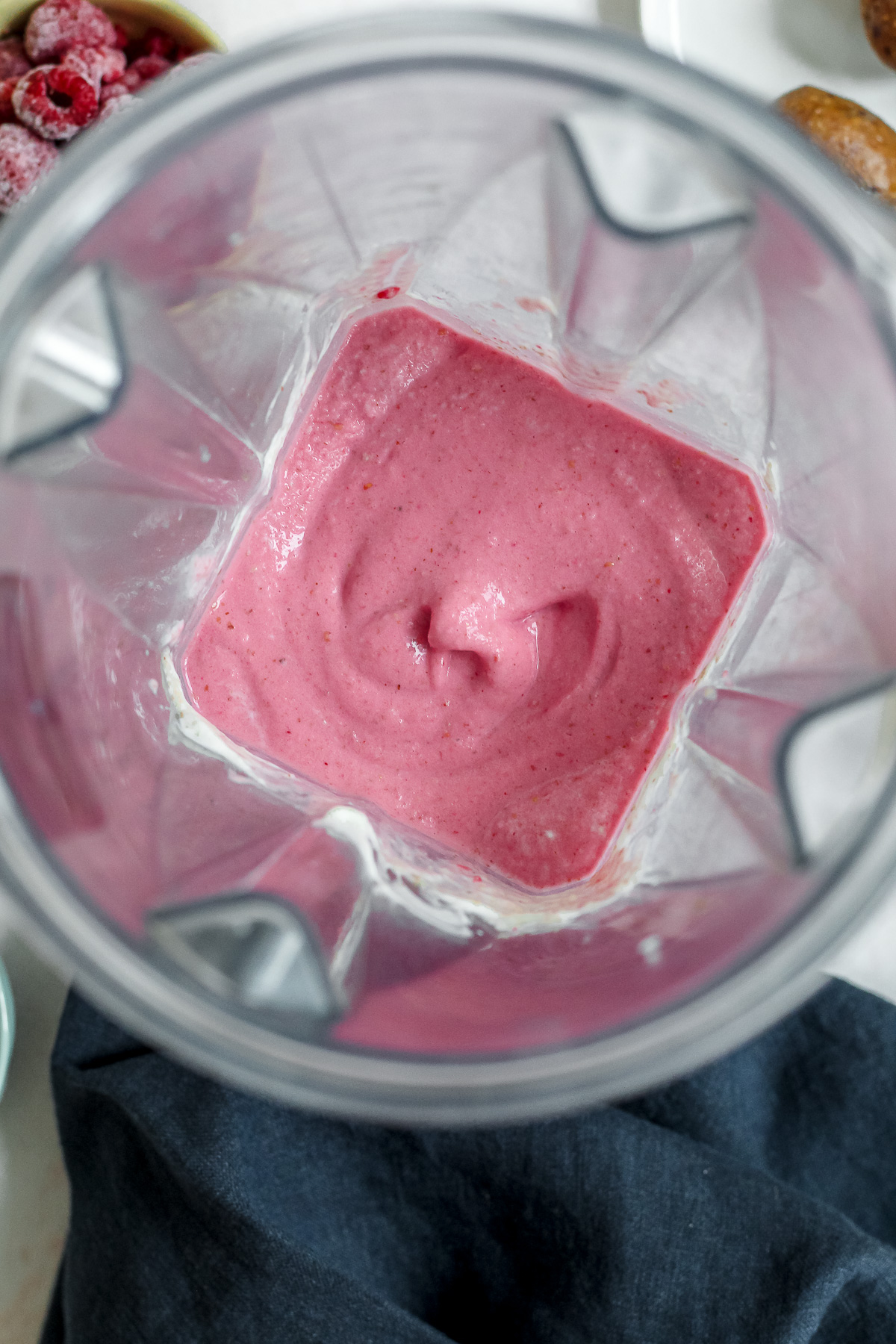 overhead shot of the blender jar once the Greek yogurt raspberry smoothie has been made