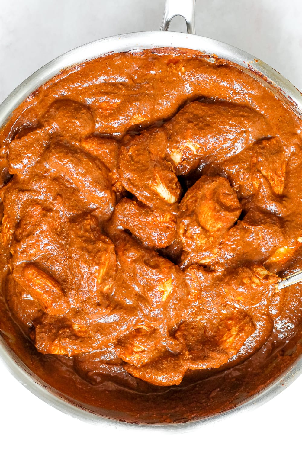 overhead shot of the mole chicken in a skillet