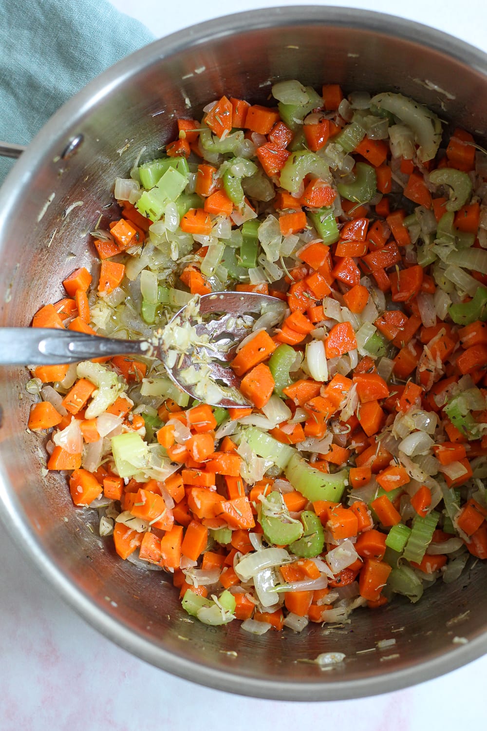 overhead process shot showing the cooked onion, garlic, carrots, celery