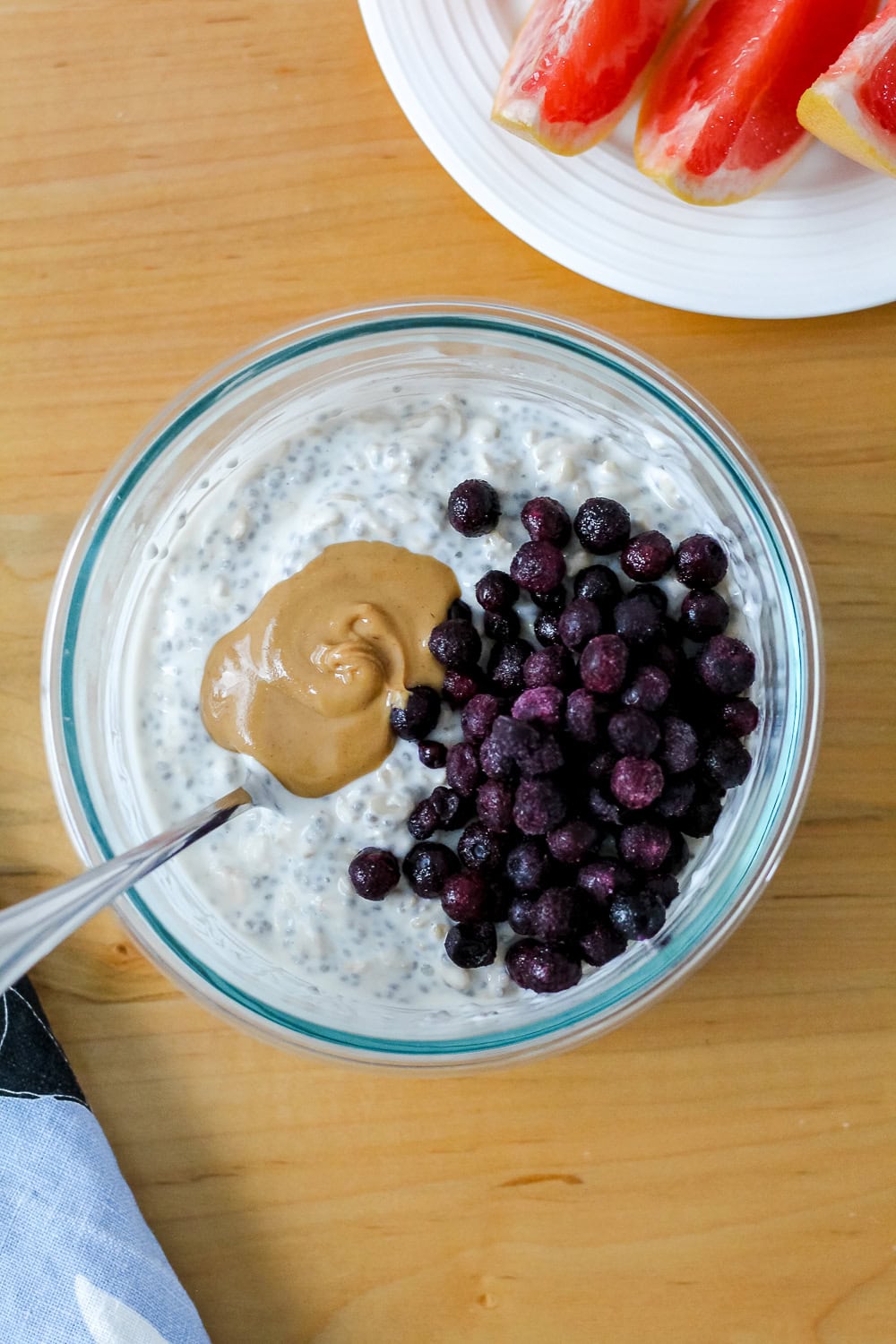 overhead photo of overnight oats topped with blueberries and peanut butter