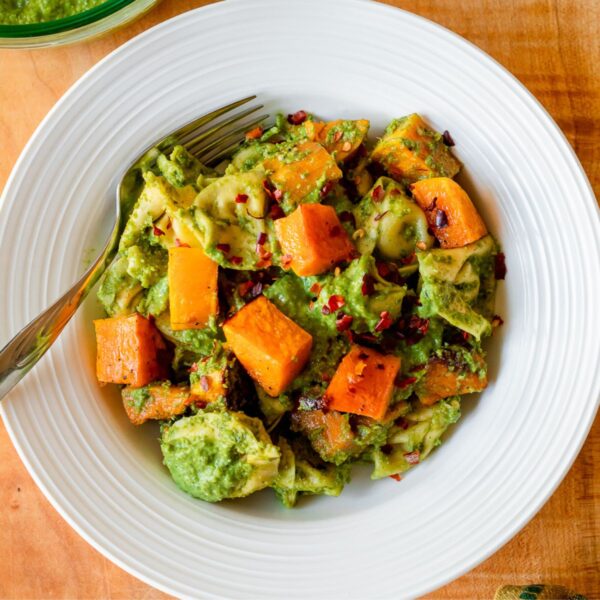 featured image for the post, an overhead photo of a bowl of the tortellini against a wooden board backdrop