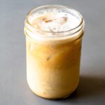 featured image for post, a large cup of pumpkin spice protein coffee on a grey table