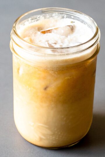 featured image for post, a large cup of pumpkin spice protein coffee on a grey table