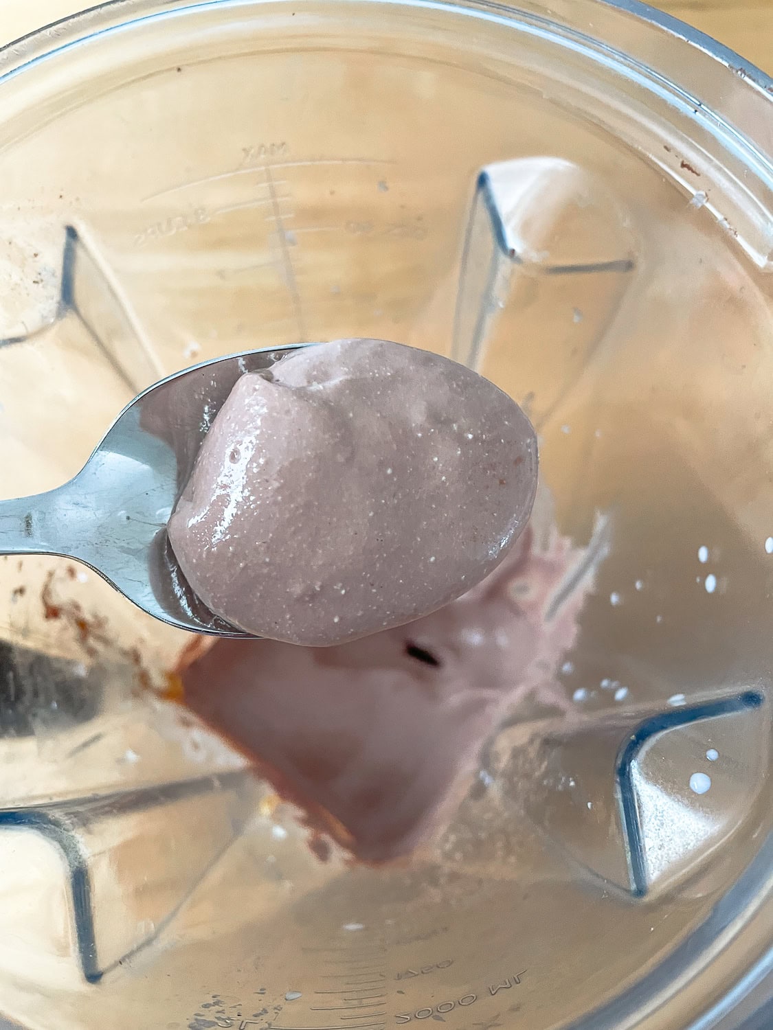 photo of the pudding once blended, on a spoon to show the texture 