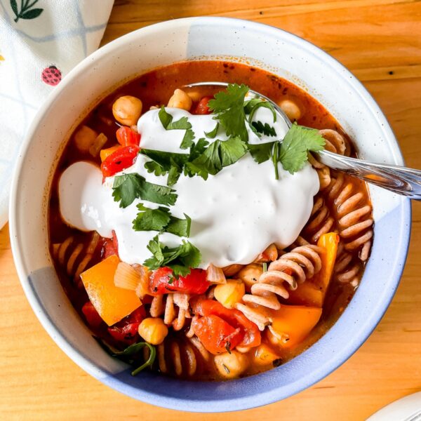 featured image for this post, an overhead photo of a bowl of the pasta topped with whipped cottage cheese and cilantro