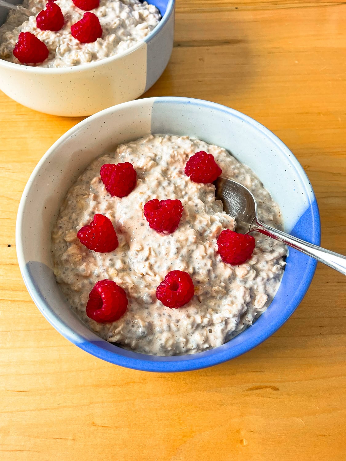 a serving of overnight oats in a blue bowl 