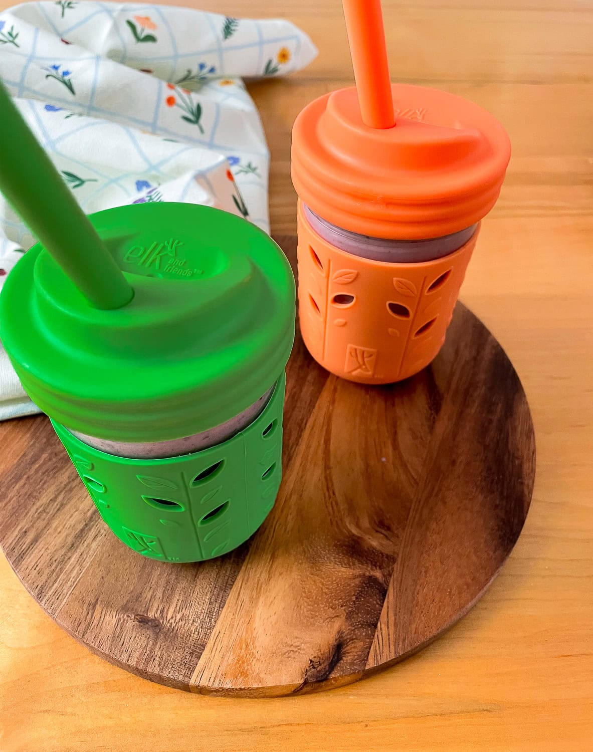 straight on photo of the smoothies in kids drinking cups on a wooden table