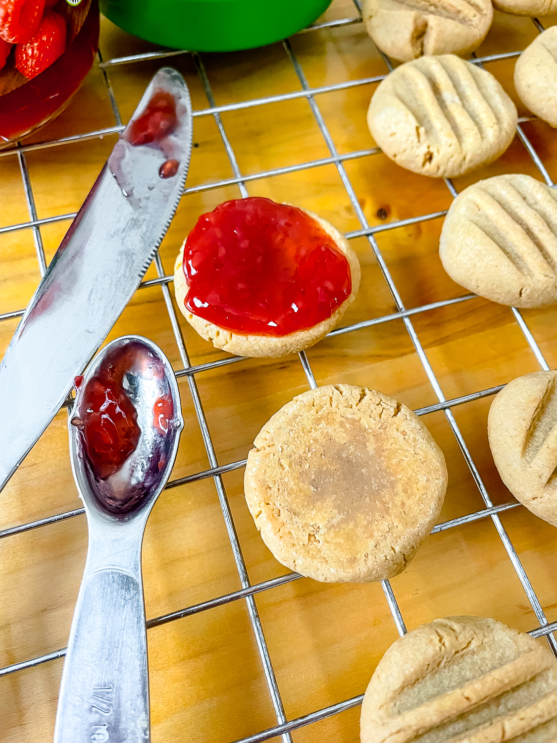 process photo of spreading the jam onto the bottoms of the cookies