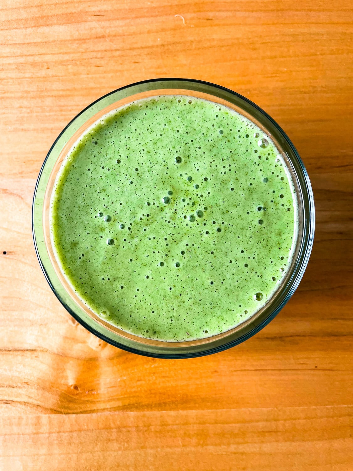 overhead photo of the lemon mint dressing in a jar on a table
