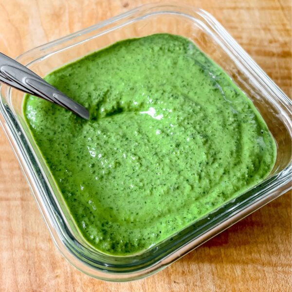 a close up photo of the pesto in a glass container