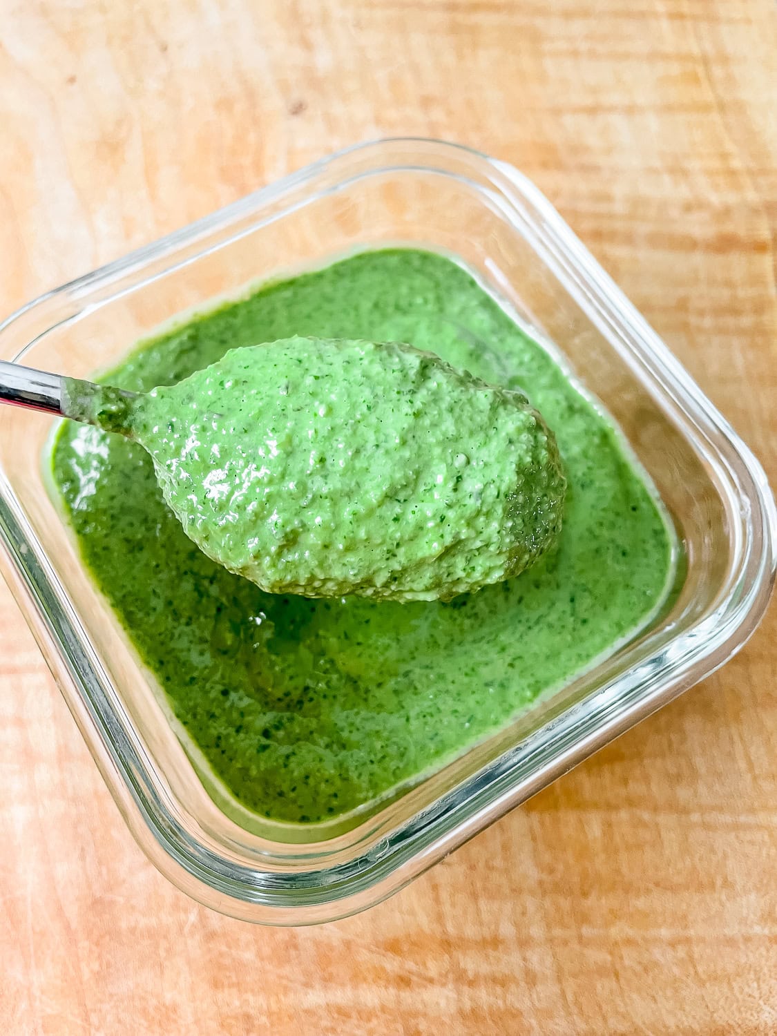 close up photo of a spoonful of the pesto