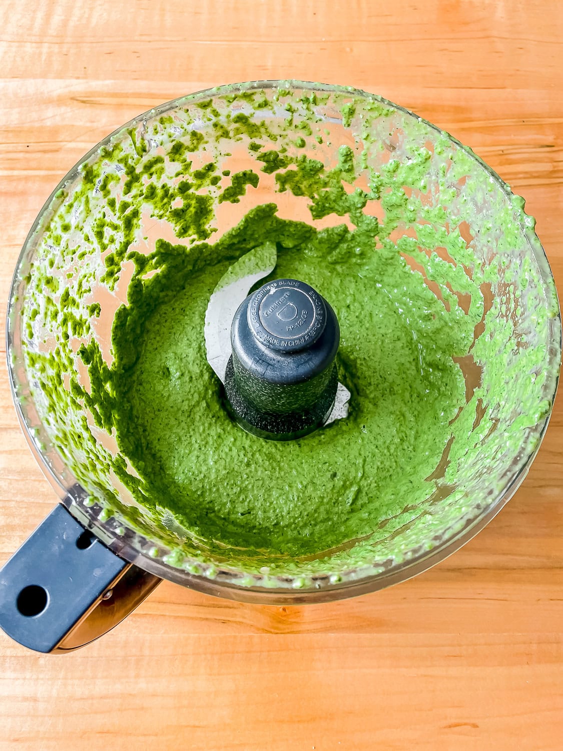 overhead photo of the pesto in a food processor once blended