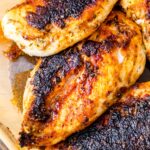 a close up of the chicken breasts that have been seared on the stove and then baked