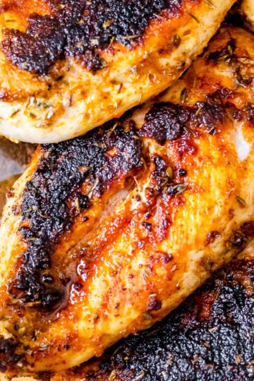 a close up of the chicken breasts that have been seared on the stove and then baked