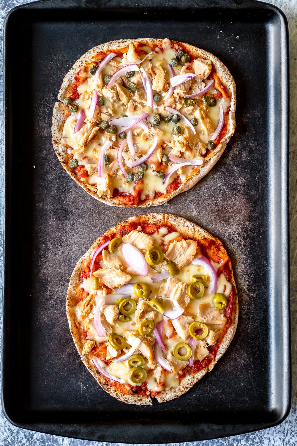a process photo showing the tuna pita pizzas once out of the oven
